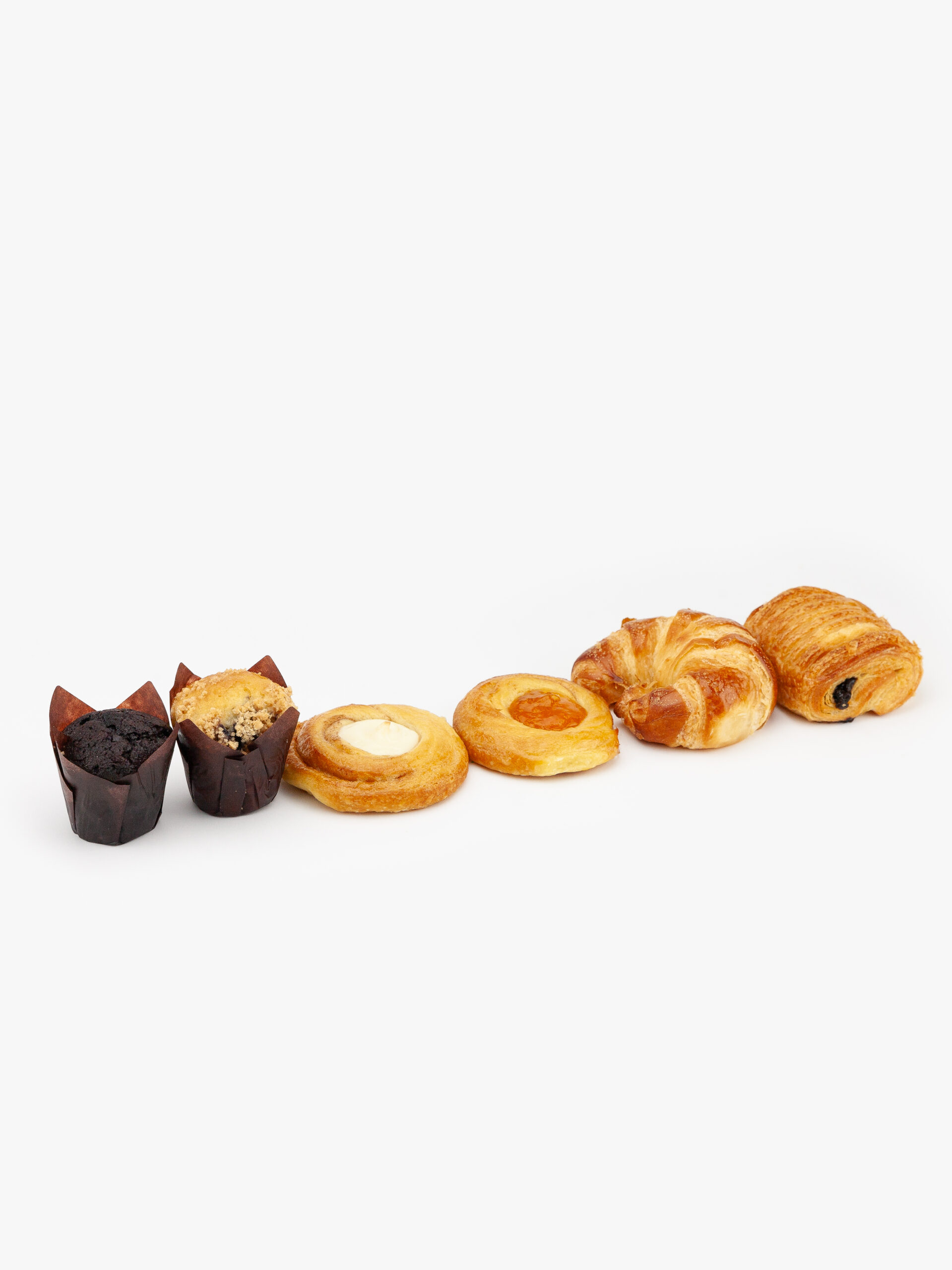 An Assortment of 6 Mini Breakfast Pastries, 2 Muffins, 2 Danish, 1 Croissant and 1 Straight Chocolate Croissant on a light grey background