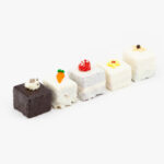 A Selection of 5 Mini Cakes on a light grey background