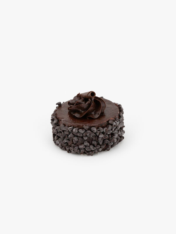 A Single 3" Individual Chocolate Cake decorated with chocolate chips on a light grey background