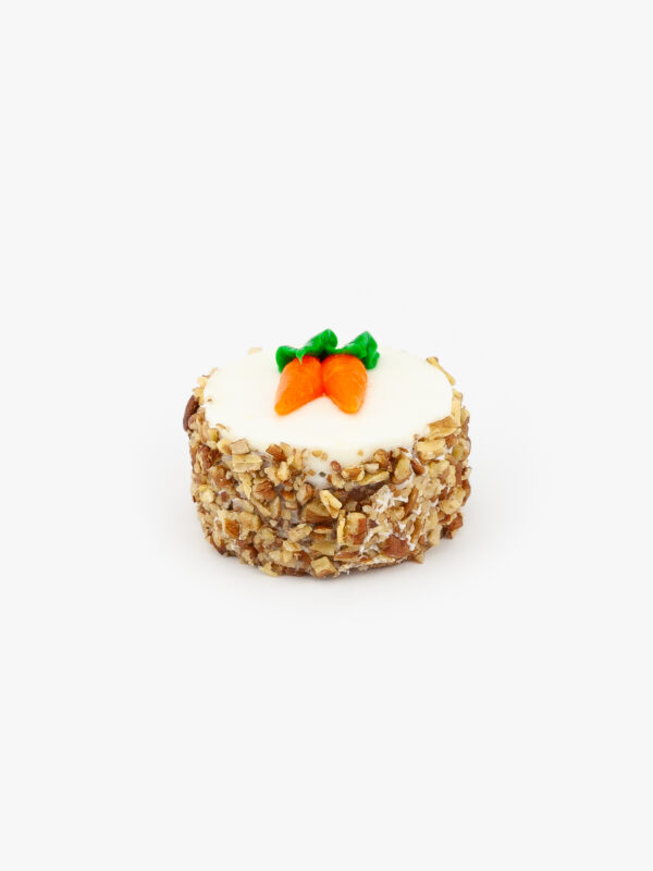 A Single 3" Individual Carrot Cake decorated with Carrots on a light grey background