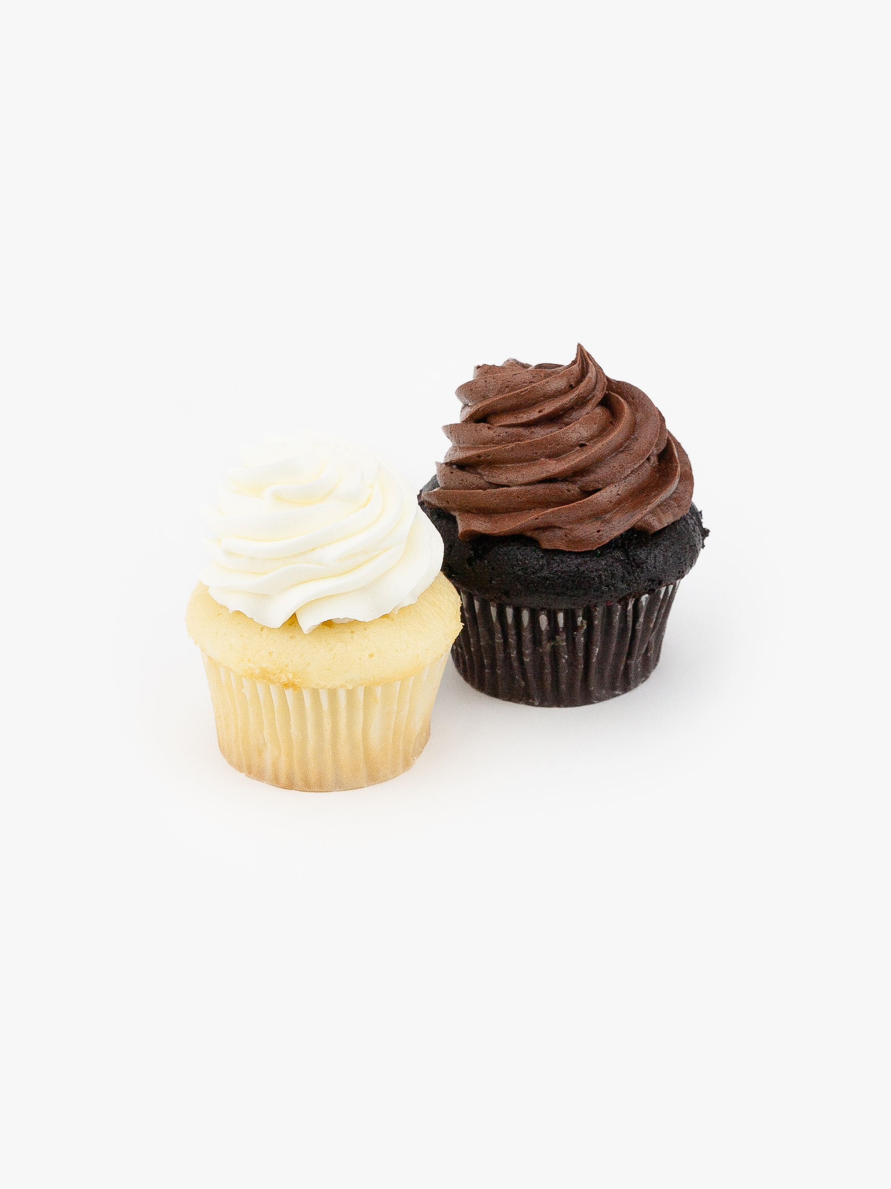 2 Regular Assorted Dessert Cupcakes in wrapping on a light grey background