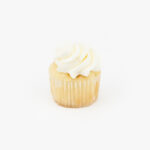 A Single Mini Vanilla Dessert Cupcake in wrapping on a light grey background