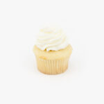 A Single Regular Vanilla Dessert Cupcake in wrapping on a light grey background