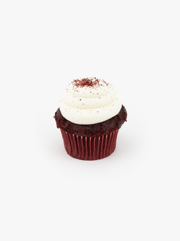 A Single Regular Red Velvet Dessert Cupcake in wrapping on a light grey background