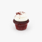 A Single Mini Red Velvet Dessert Cupcake in wrapping on a light grey background