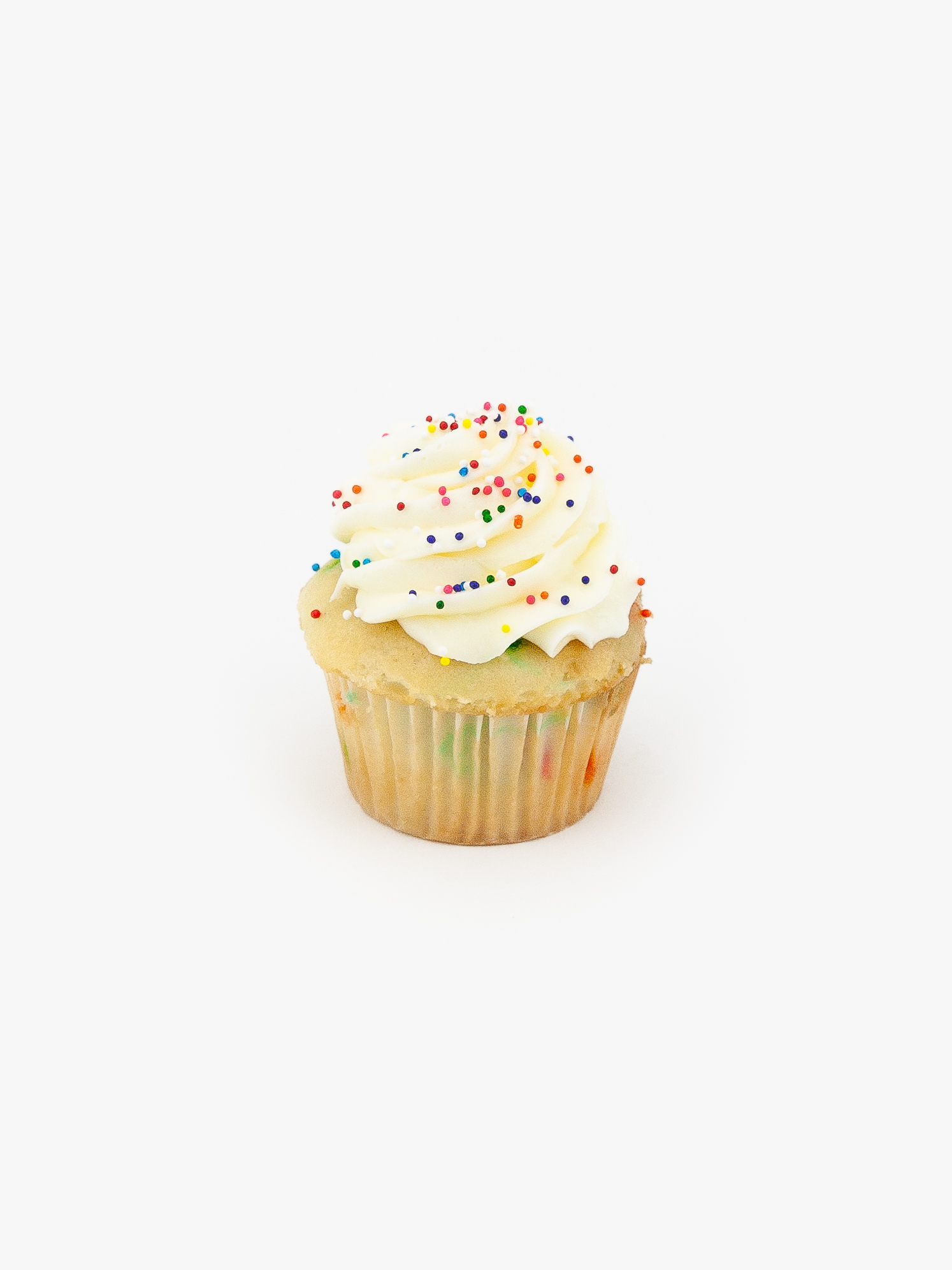 A Single Regular Confetti Dessert Cupcake in wrapping on a light grey background