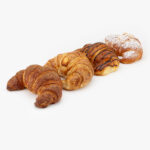 An Assortment of 4 Jumbo Curved Croissants, Churro, Almond, Chocolate and Butter on a light grey background