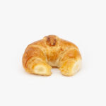 A Single Regular Curved Butter Breakfast Croissant perfectly baked on a light grey background