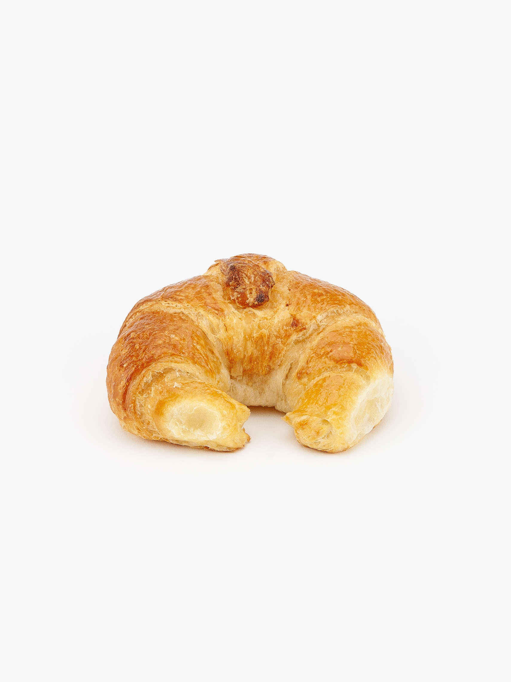 A Single Regular Curved Butter Breakfast Croissant perfectly baked on a light grey background