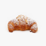 A Single Curved Jumbo Almond Breakfast Croissant on a light grey background