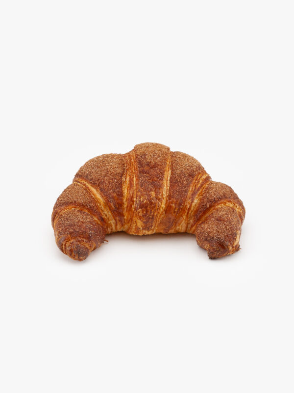 A Single Curved Jumbo Churro Breakfast Croissant on a light grey background