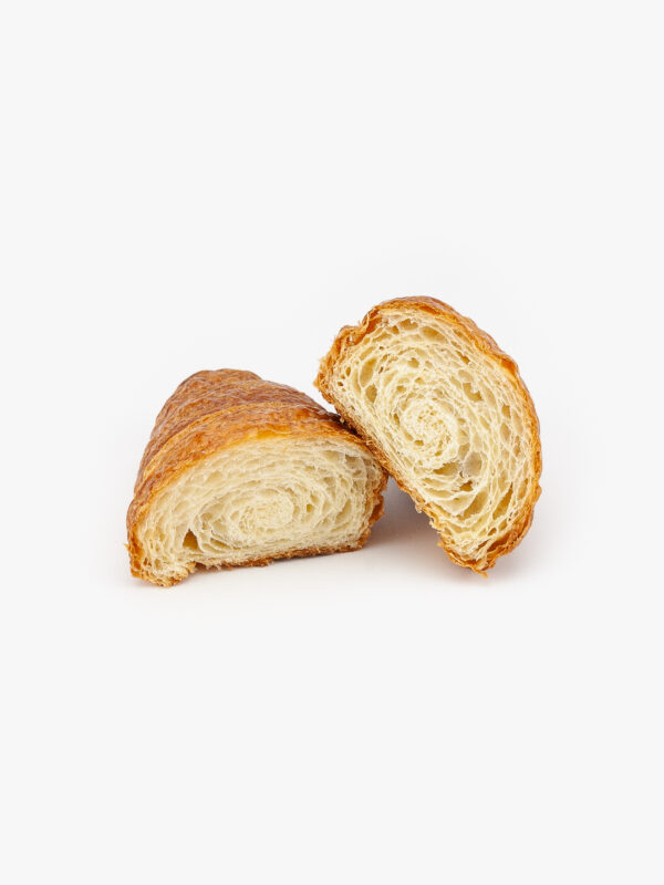 A Single Straight Jumbo Butter Breakfast Croissant Cut Open on a light grey background