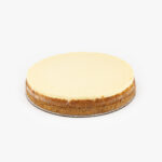 A Single 10" Round New York No Cut Cheesecake individually sectioned on a light grey background