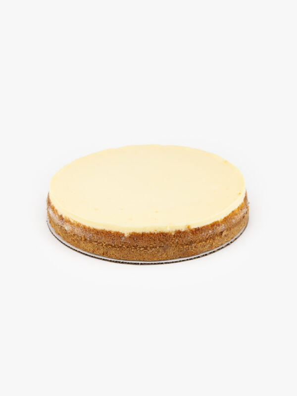 A Single 10" Round New York No Cut Cheesecake individually sectioned on a light grey background