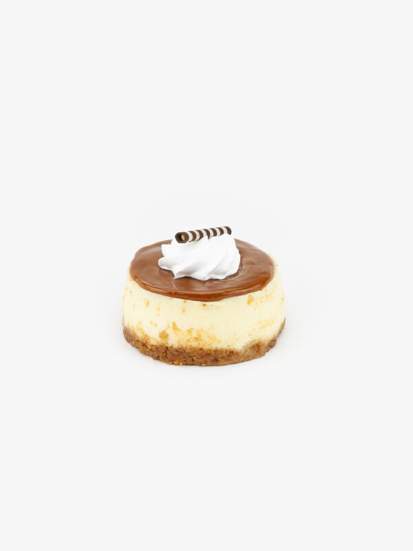 A Single 3" Individual Round Dulce De Leche Cheesecake on a light grey background