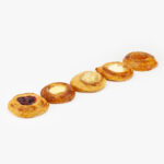 5 Mini Round Assorted Breakfast Danish perfectly baked on a light grey background