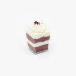 A Single Regular Red Velvet Dessert Parfait Cup on a light grey background