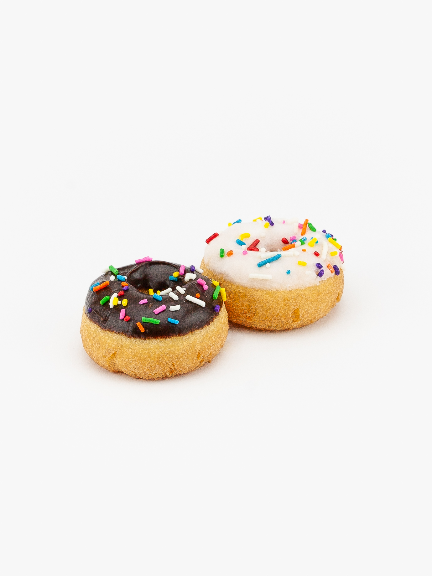 Two Mini Assorted Cake Donuts with sprinkles on a light grey background