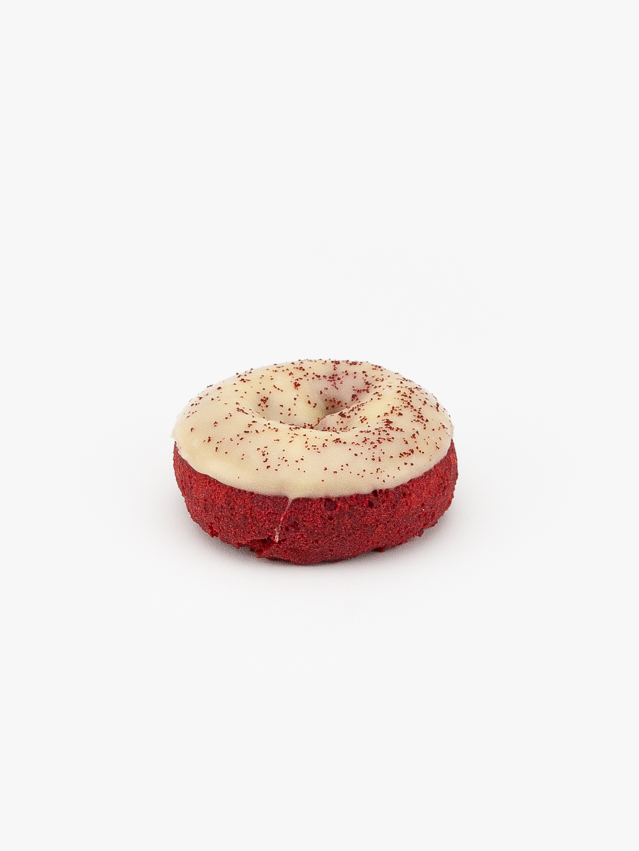 A Regular Red Velvet Cake Donut on a light grey background