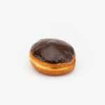 A Regular Cream Filled Donut with Chocolate Glaze on light grey background