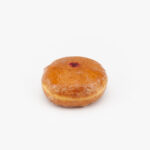 A Regular Raspberry Filled Donut on a light grey background