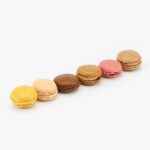 6 Assorted Mini French Macaron Dessert Pastries on a light grey background