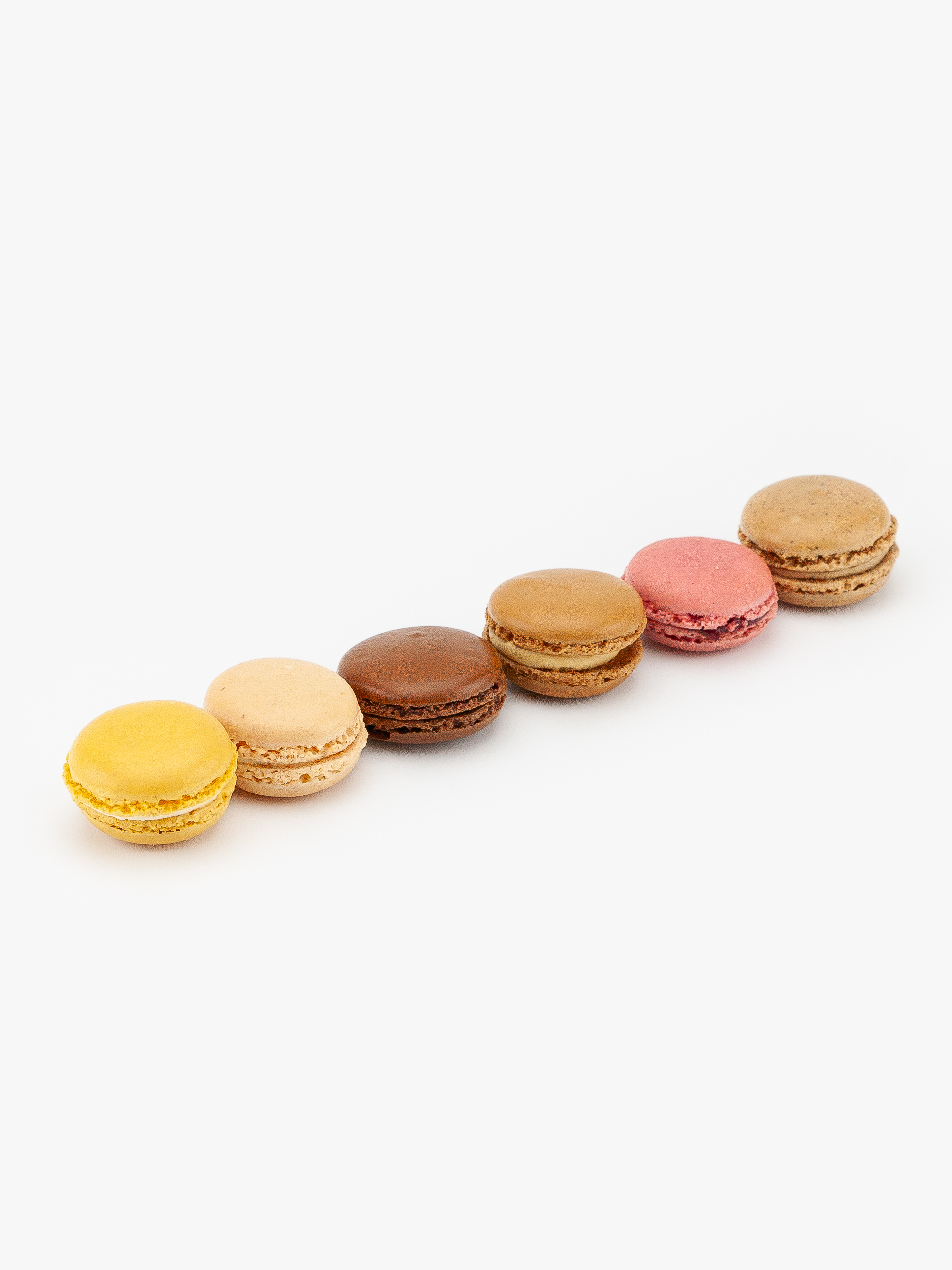 6 Assorted Mini French Macaron Dessert Pastries on a light grey background