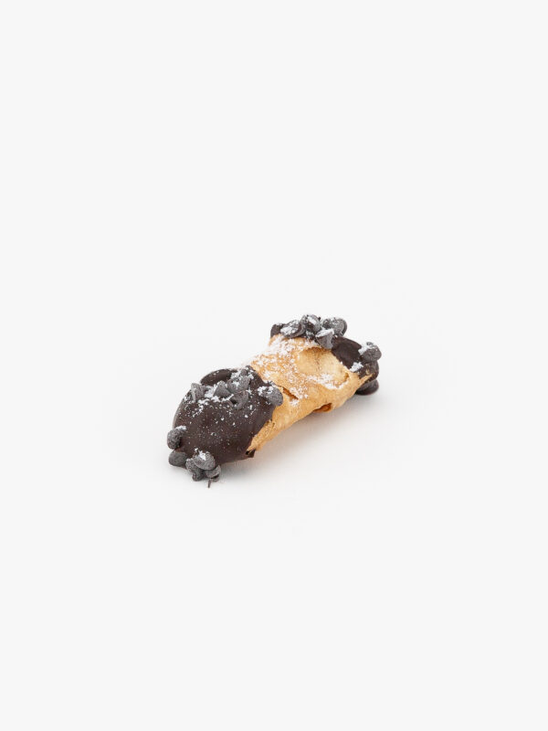 A Single Cannoli Mini Dessert Pastry on a light grey background