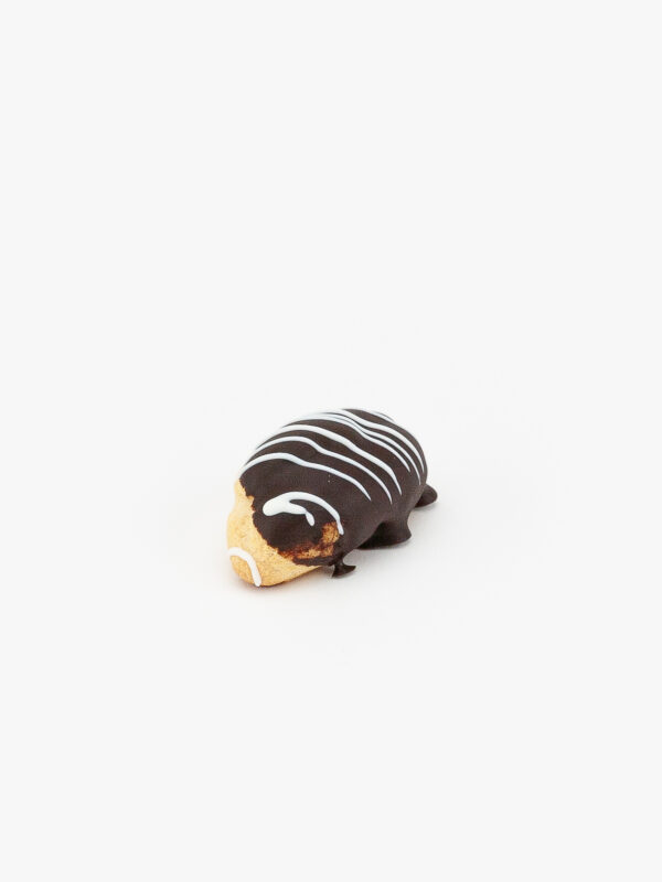 A Single Eclair Mini Dessert Pastry on a light grey background