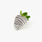 A Single White Chocolate Dipped Strawberry Dessert Pastry on a light grey background