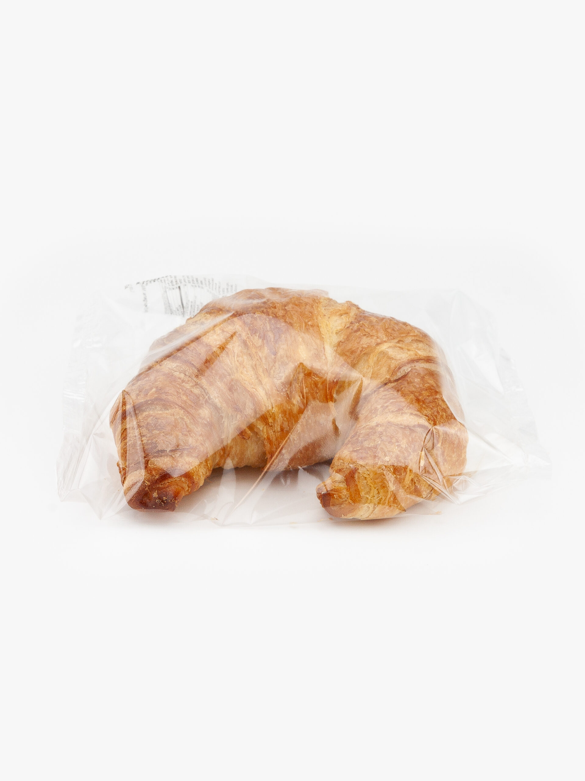 An Individually Wrapped Jumbo Butter Croissant in recyclable material on a light grey background