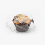 A Single Individual Wrapped Jumbo Blueberry Muffin Sealed in Plastic on a light grey background