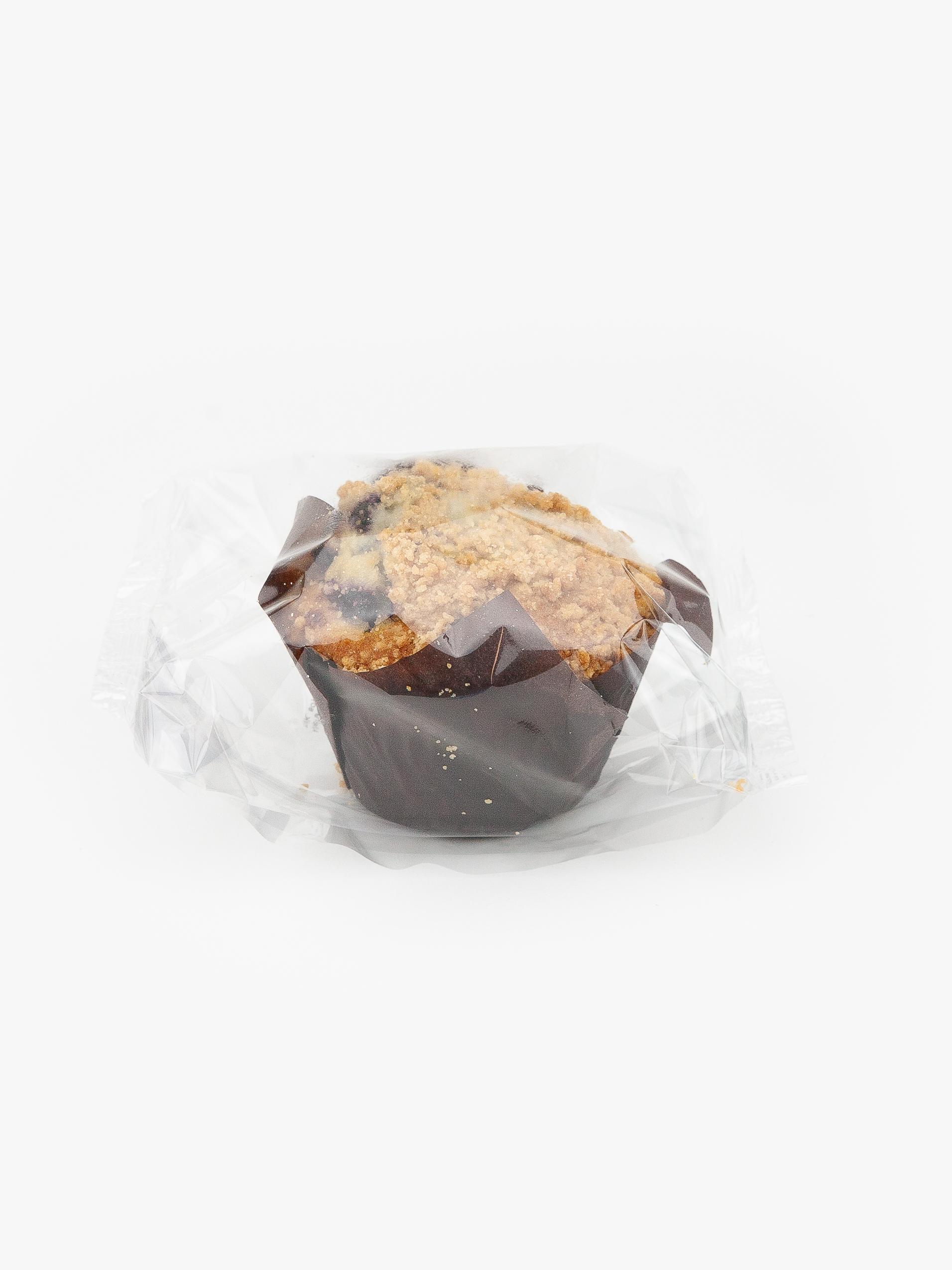 A Single Individual Wrapped Jumbo Blueberry Muffin Sealed in Plastic on a light grey background