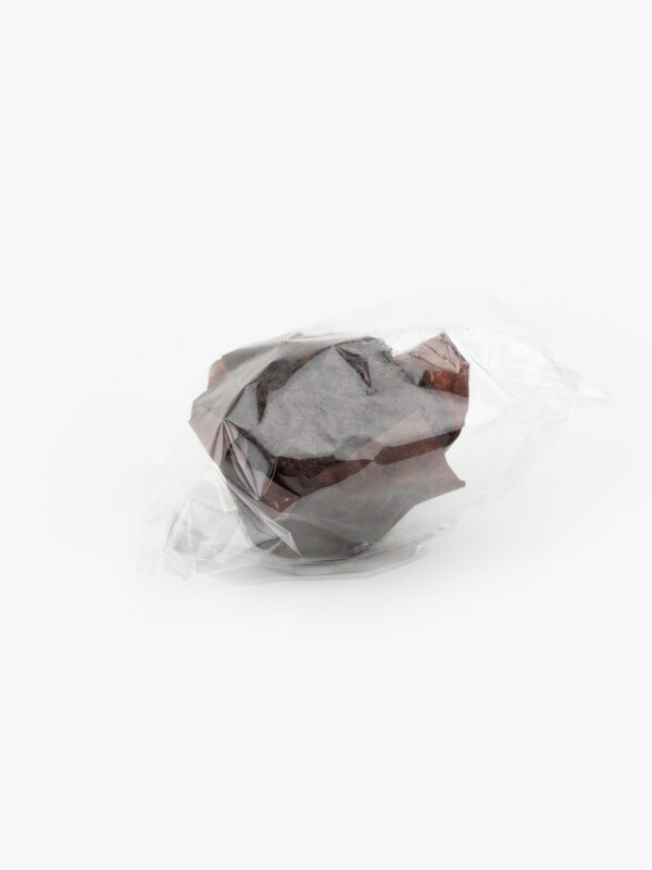 An Individually Wrapped Jumbo Chocolate Muffin in recyclable material on a light grey background