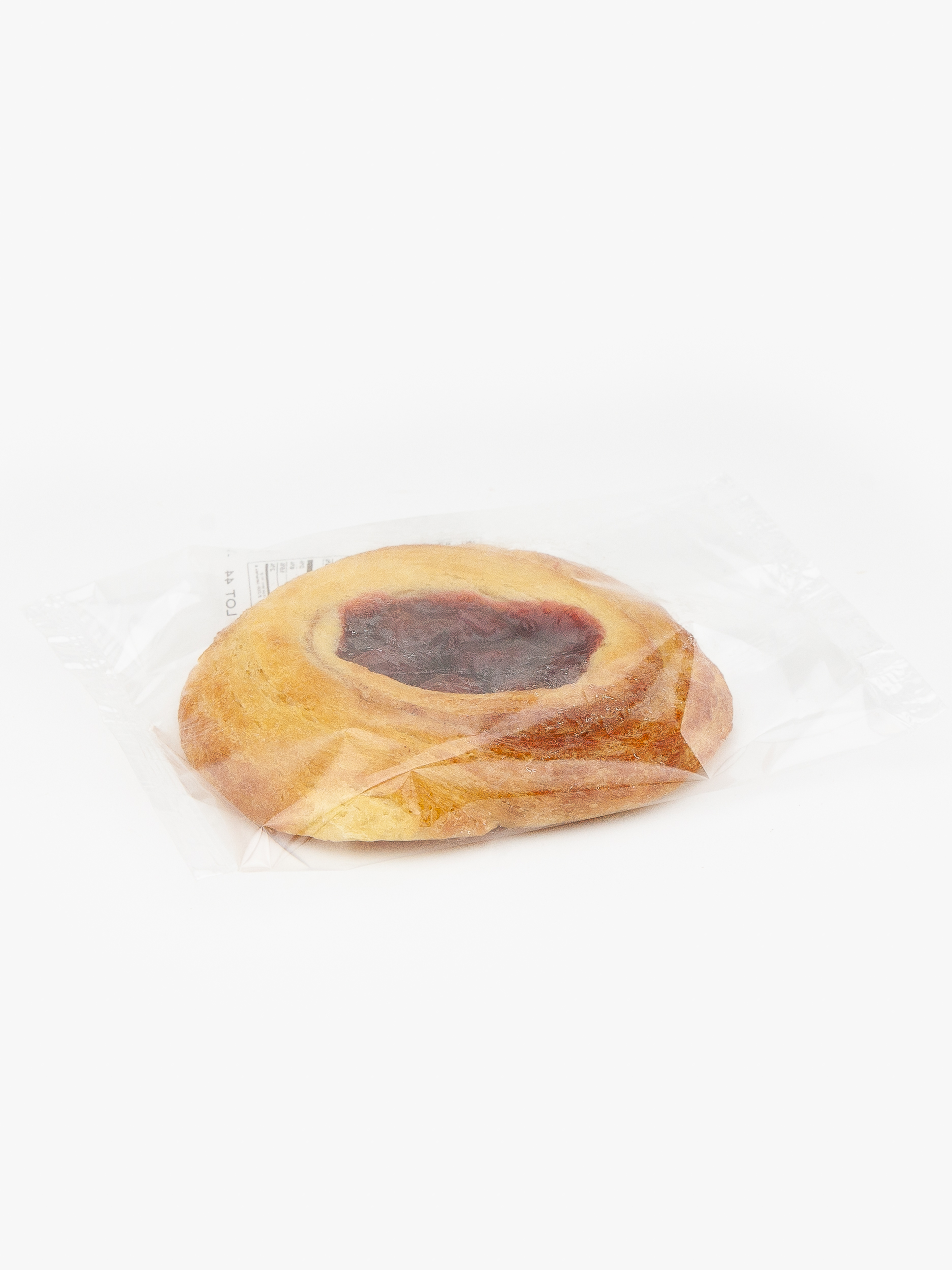 A Single Individual Wrapped Jumbo Cherry Danish Sealed in Plastic on a light grey background