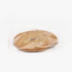 A Single Individual Wrapped Jumbo Chocolate Cookie Sealed in Plastic on a light grey background