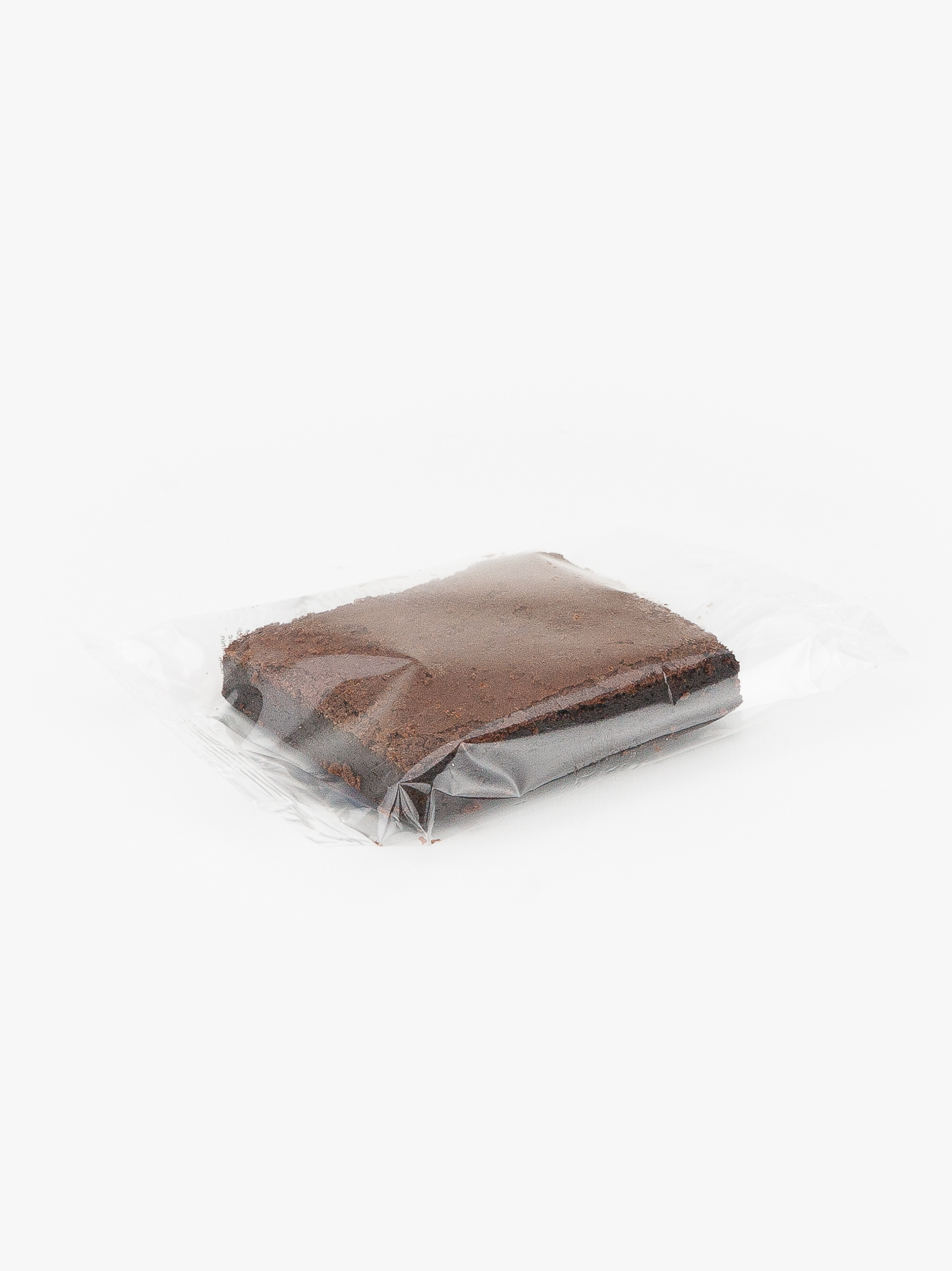 A Single Individual Wrapped Plain 3x3 Brownie Sealed in Plastic on a light grey background