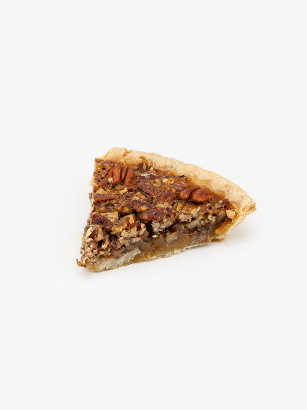 A slice of Baked Pecan Pie on a light grey background