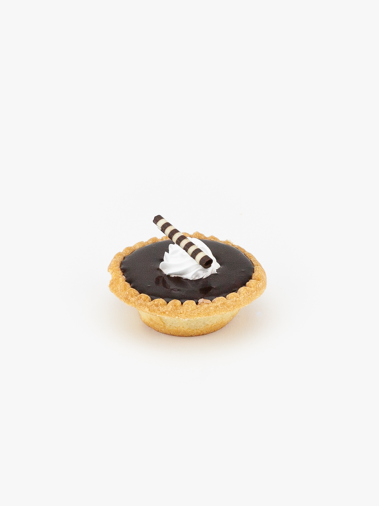 A Individual Mini Chocolate Cream Pie with Chocolate Topping on a light grey background