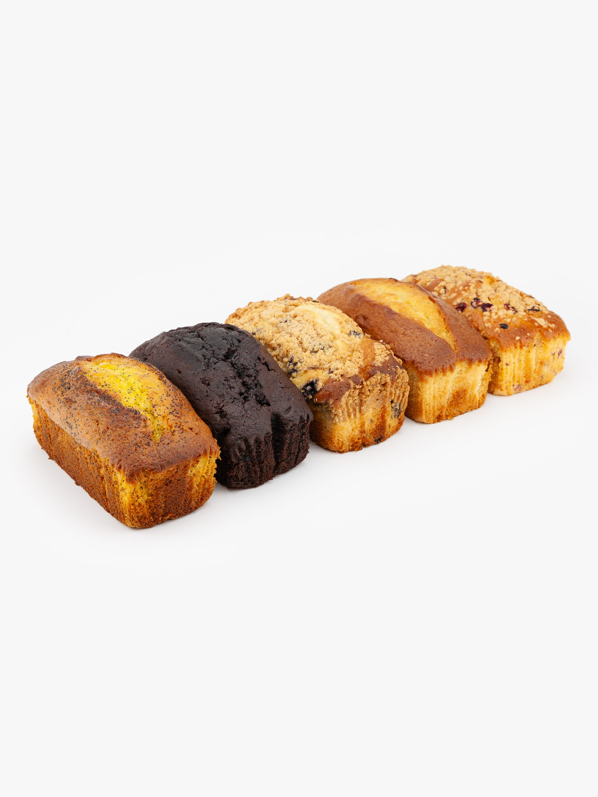 A line of assorted pound cakes no cut, Lemon Poppy, Chocolate, Cranberry Orange, Blueberry and Banana.