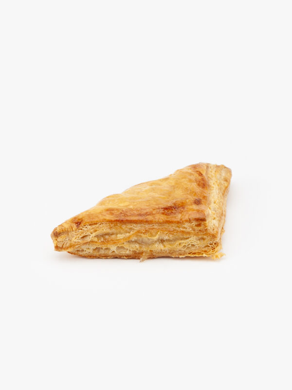 A Jumbo Apple Puff Pastry cut open on a light grey background