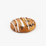 A Jumbo Round Chocolate Chip Breakfast Scone on a light grey background