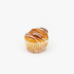 A Mini Cinnamon Breakfast Sweet Roll on a light grey background