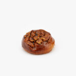 A Jumbo Sticky Pecan Breakfast Sweet Roll on a light grey background