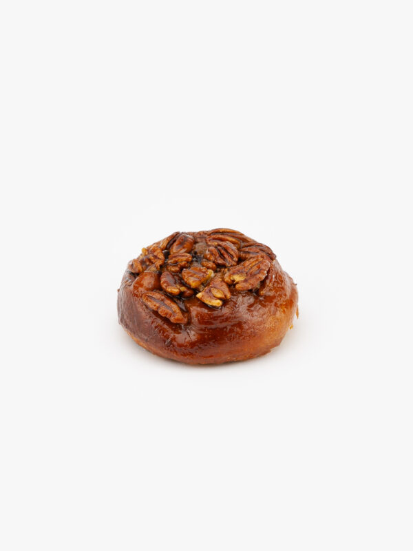 A Jumbo Sticky Pecan Breakfast Sweet Roll on a light grey background