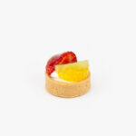 A Fresh Fruit Mini Dessert Tart on light grey background