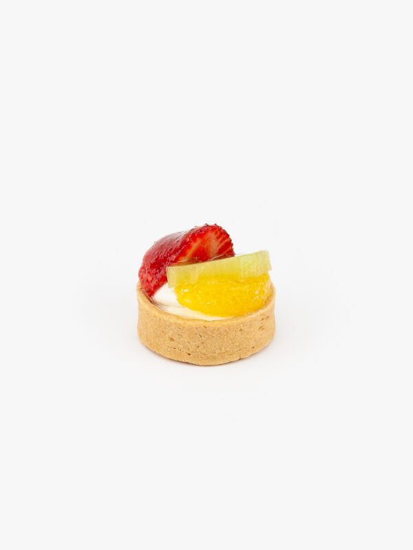 A Fresh Fruit Mini Dessert Tart on light grey background