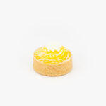 A Lemon Mini Dessert Tart on light grey background