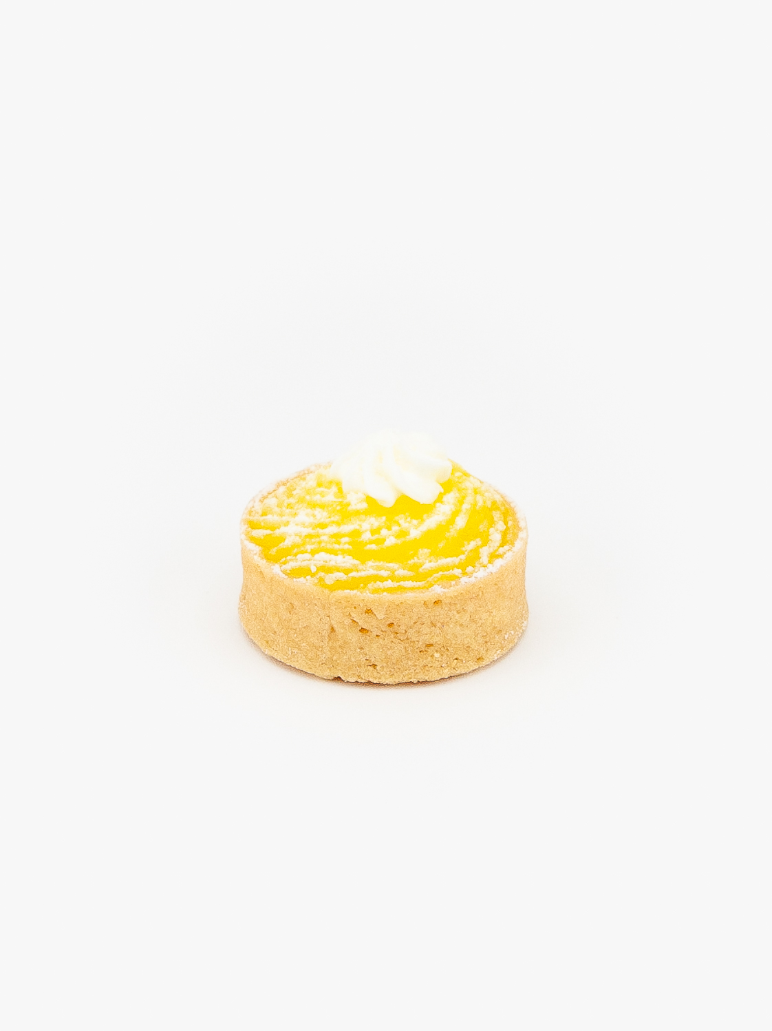 A Lemon Mini Dessert Tart on light grey background