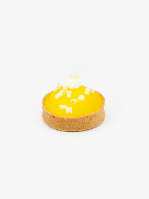 A Lemon Individual Dessert Tart on a light grey background.